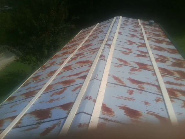 Rusted metal roof panels with new wood purlins before replacement — Storm Damage Roof Repair in New Pine Creek by Roofing Brothers